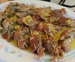 Involtini di capocollo con pancetta e pistacchi al profumo di arancia